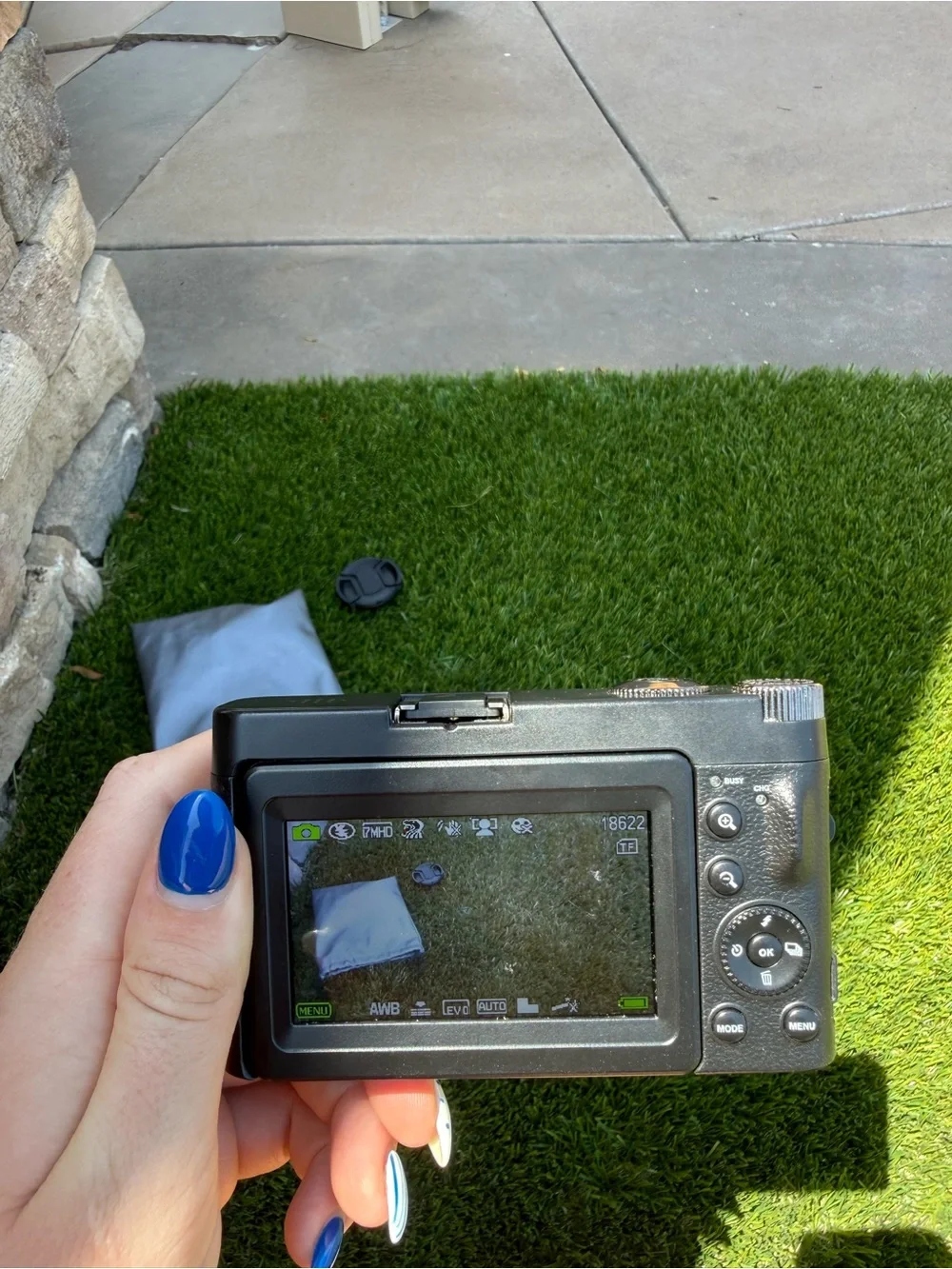 Compact Black Digital Camera with Accessories and Lens Cap